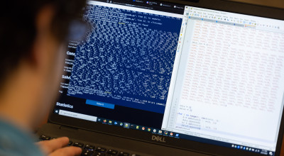 A photo of a researcher participating in a hackathon/CTF event at GTRI.