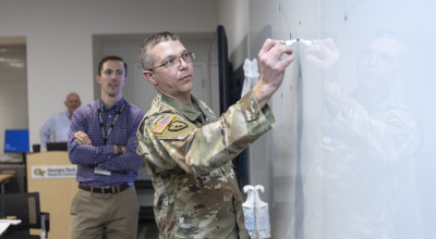 Participants of the Georgia Army Nation Guard working group brainstorm ideas on the whiteboard. (Credit: Christopher Moore)