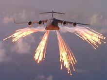 Big plane with flares coming out of wings